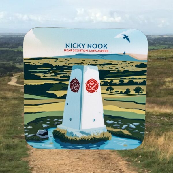 Image of a coaster with 'Nicky Nook' written on it on a background of a grassy walking trail.