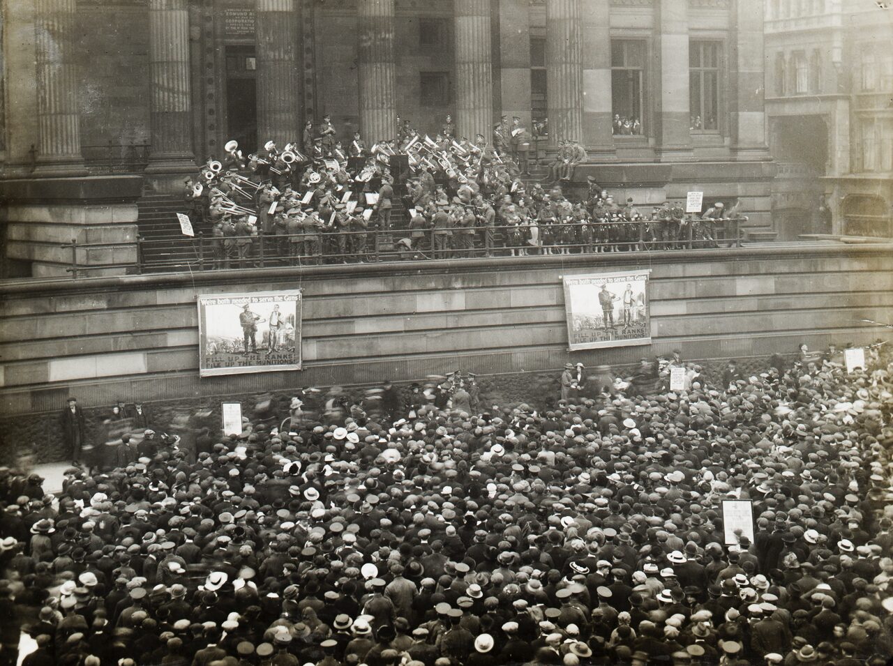A black and white photo of soldiers on the balcony of the Harris.