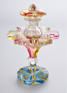 A pink, blue and clear glass shaped bottle.