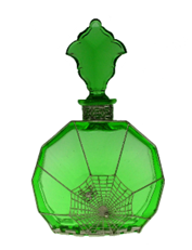 A green circular glass bottle decorated with a spider and web.
