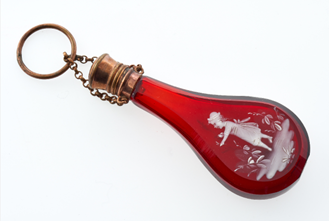 A red glass bottle in the shape of a pear.