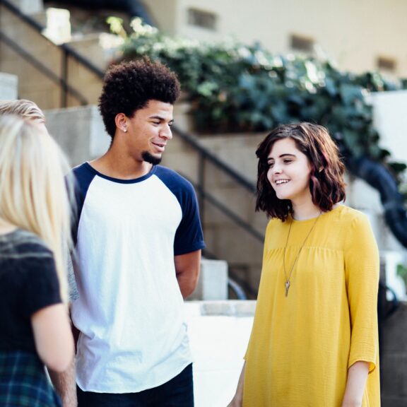 three young people having a conversation