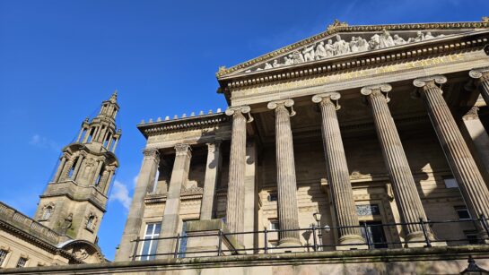 An exterior view of the Harris and Sessions House with blue sky in the background.