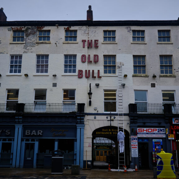 Image of a large white building with 'The Old Bull' written in red capital letters.