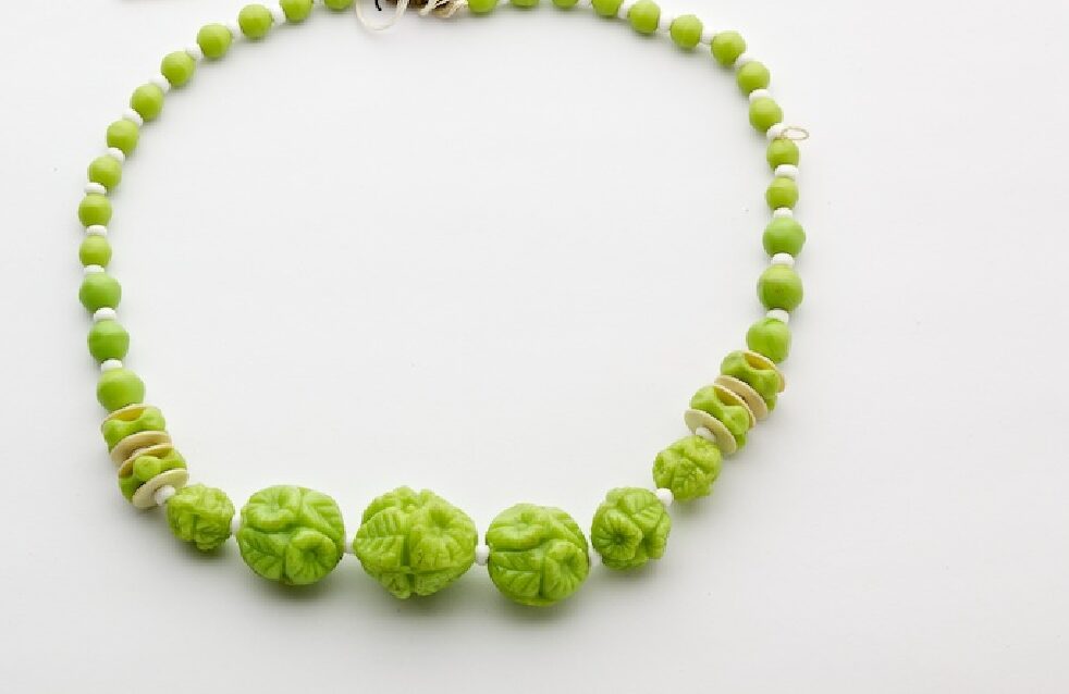 Green moulded, opaque glass necklace.