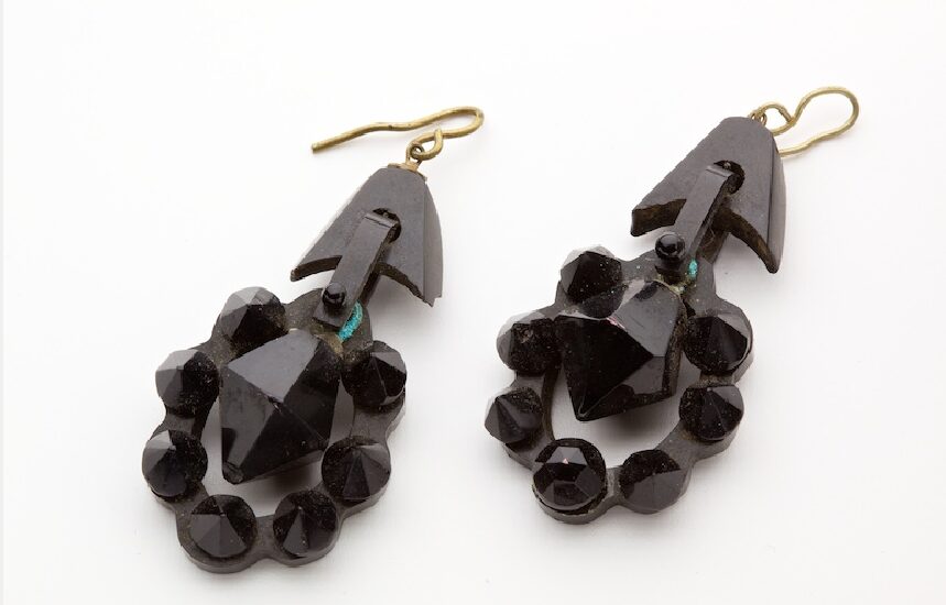 A pair of morning earrings with a studded oval outer and a twelve-sided teardrop.