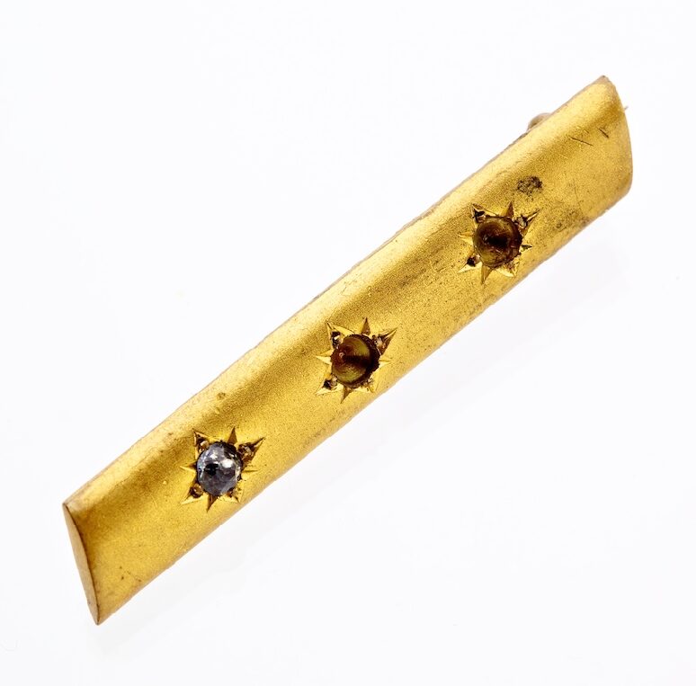 A scarf pin brass bar.