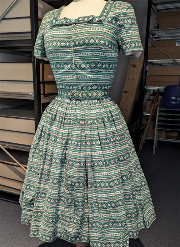 A white and green geometric print dress.