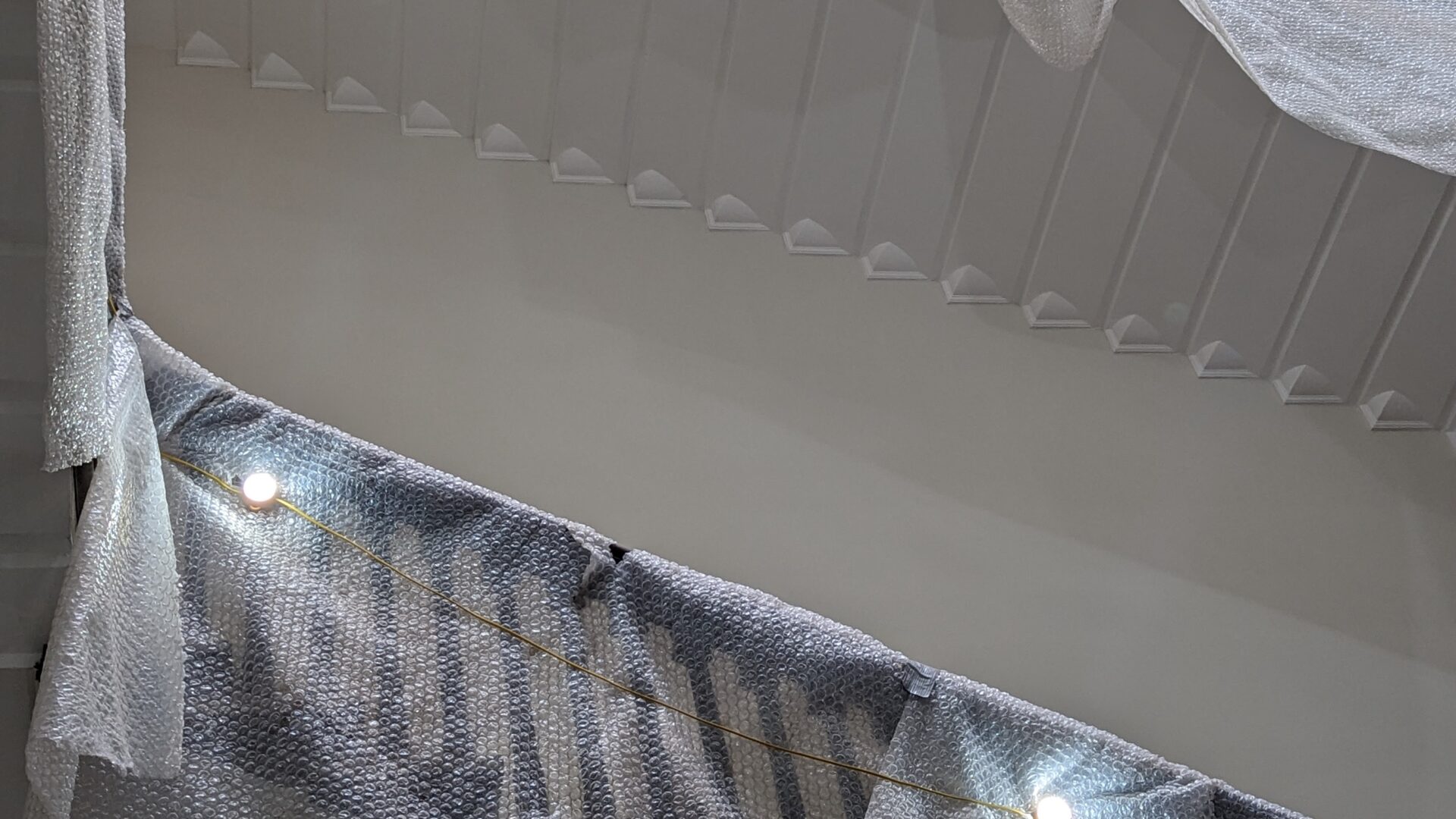 Image of staircases covered with protective sheets.