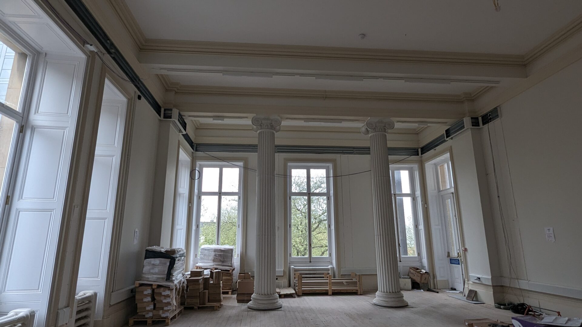 Image of a large white room with wooden floors.