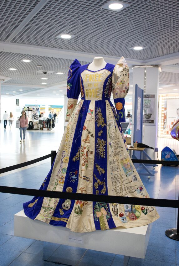 Image of a patchwork blue, gold and white dress.