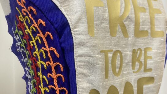 A cream and blue bodice featuring the words 'free to be me'.