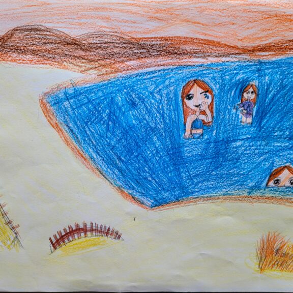 Image of a beach scene with three people.