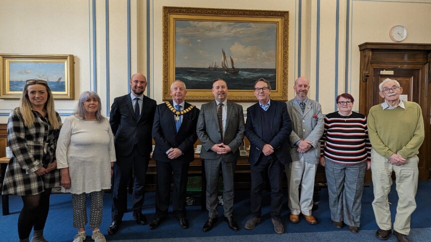 Image of a people stood in front of a painting
