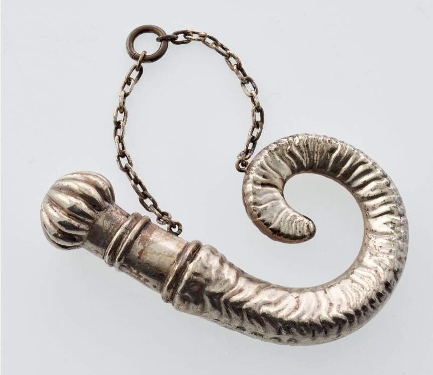 A silver spiral shaped scent bottle.