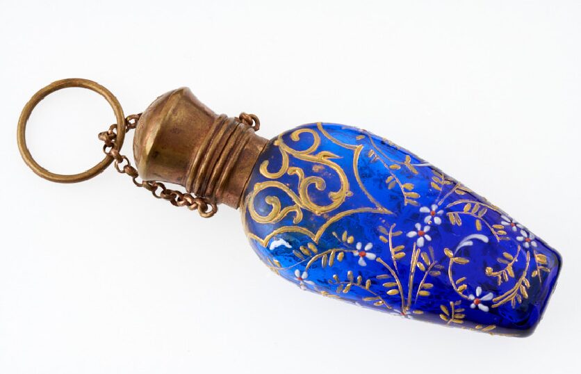 A gold and blue patterned scent bottle.